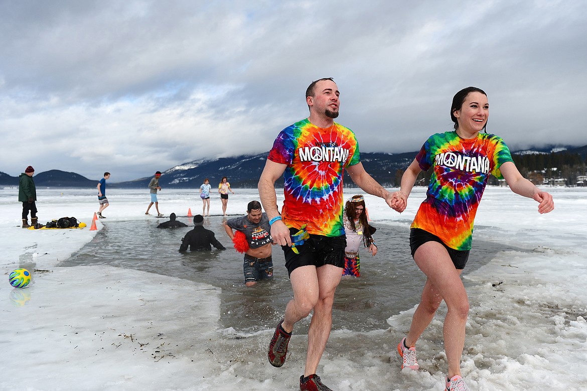 Participants step out of Whitefish Lake during the Whitefish Winter Carnival Penguin Plunge 2019 on Saturday. (Casey Kreider/Daily Inter Lake)