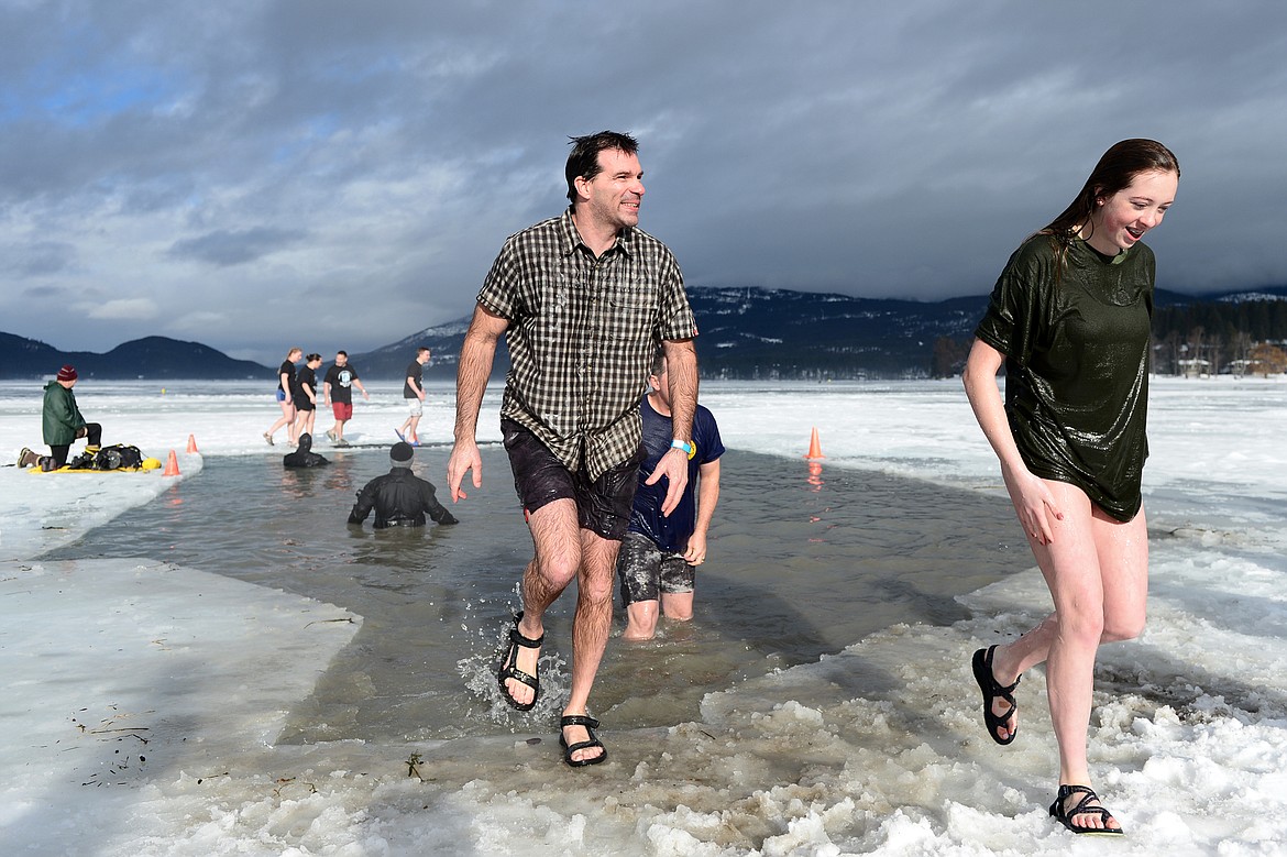 New Kalispell police chief Doug Overman, center, steps out of Whitefish Lake during the Whitefish Winter Carnival Penguin Plunge 2019 on Saturday. (Casey Kreider/Daily Inter Lake)