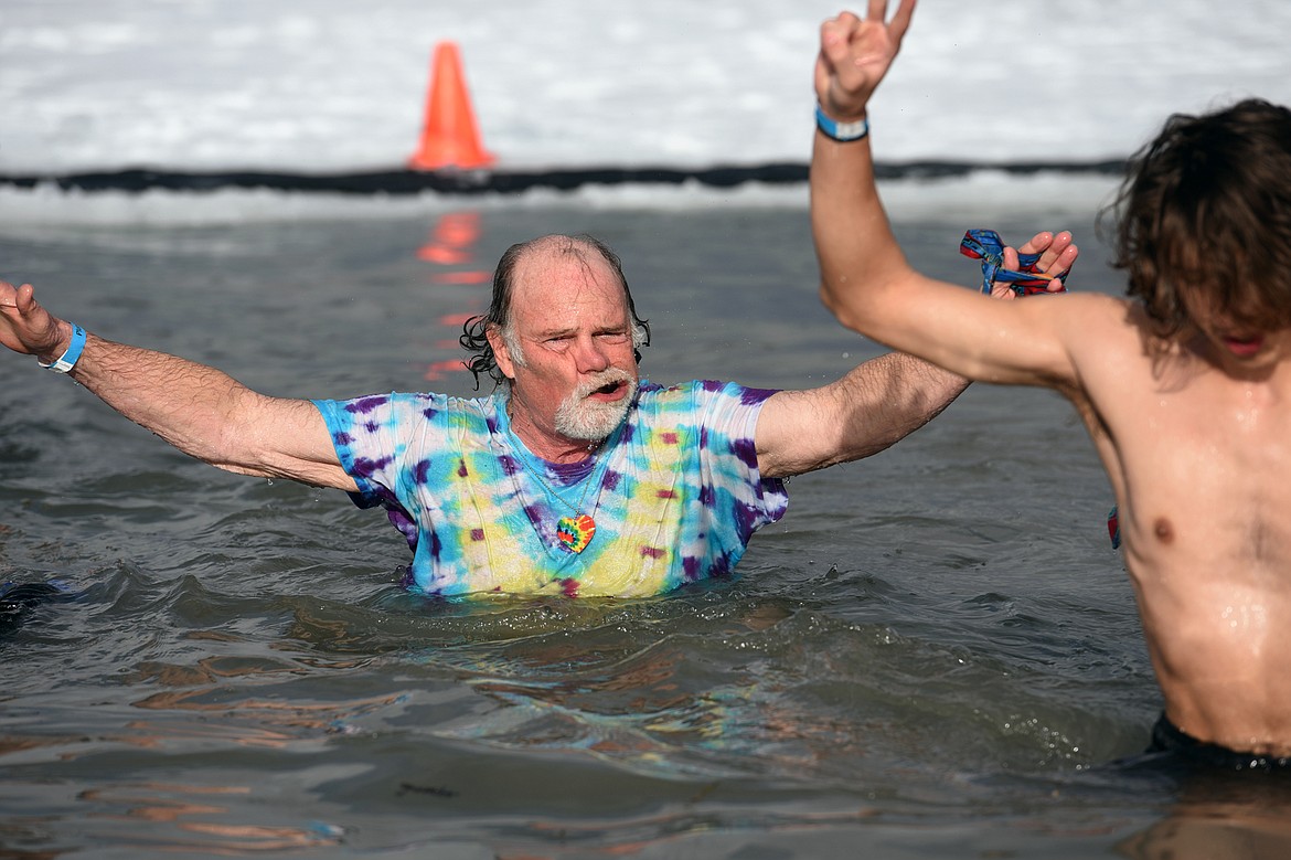 Paul Coats, left, King Ullr LX in the Whitefish Winter Carnival Royal Court, shakes off after leaping into Whitefish Lake during the Whitefish Winter Carnival Penguin Plunge 2019 on Saturday. (Casey Kreider/Daily Inter Lake)