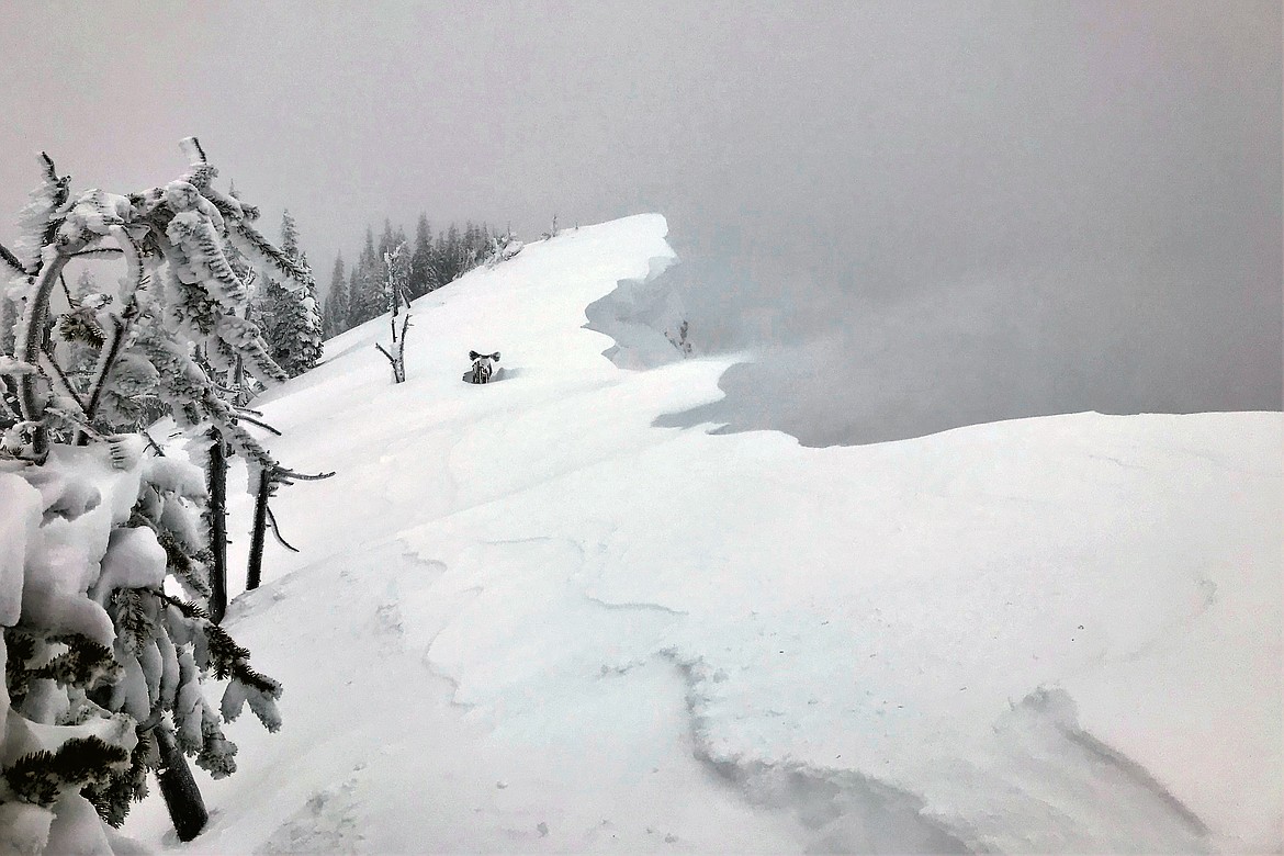 A snow bike belonging to Marty Mann sits near the approximate location of a cornice fall near the summit of Spring Slide Mountain in the southern Swan Range. (Flathead Avalanche Center photo)