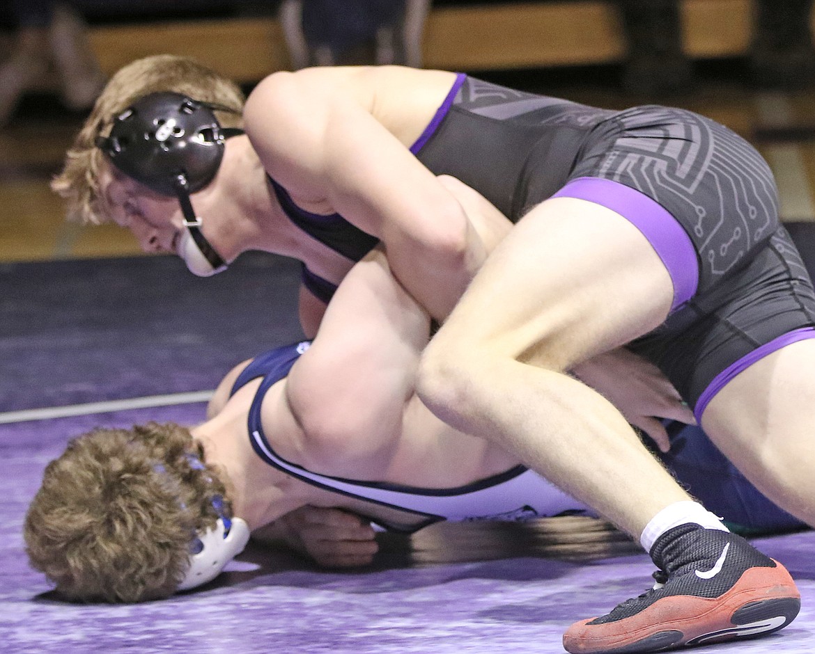 Polson senior Bridger Wenzel, on top above, won the 152-pound title at the Western A Divisional. He pinned Hunter Hoover of Libby in his title match. (Bob Gunderson/Lake County Leader)