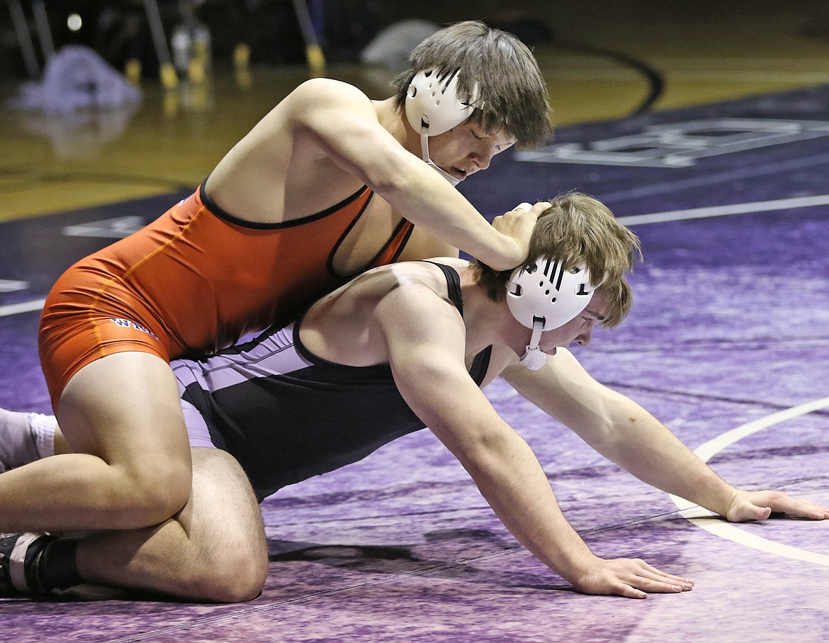 Ronan senior Justin Mays, pictured in orange singlet, won the 205-pound class at the Western A Divisional in Butte. He pinned Jakob Freeman of Columbia Falls in the title match. (Bob Gunderson/Lake County Leader)