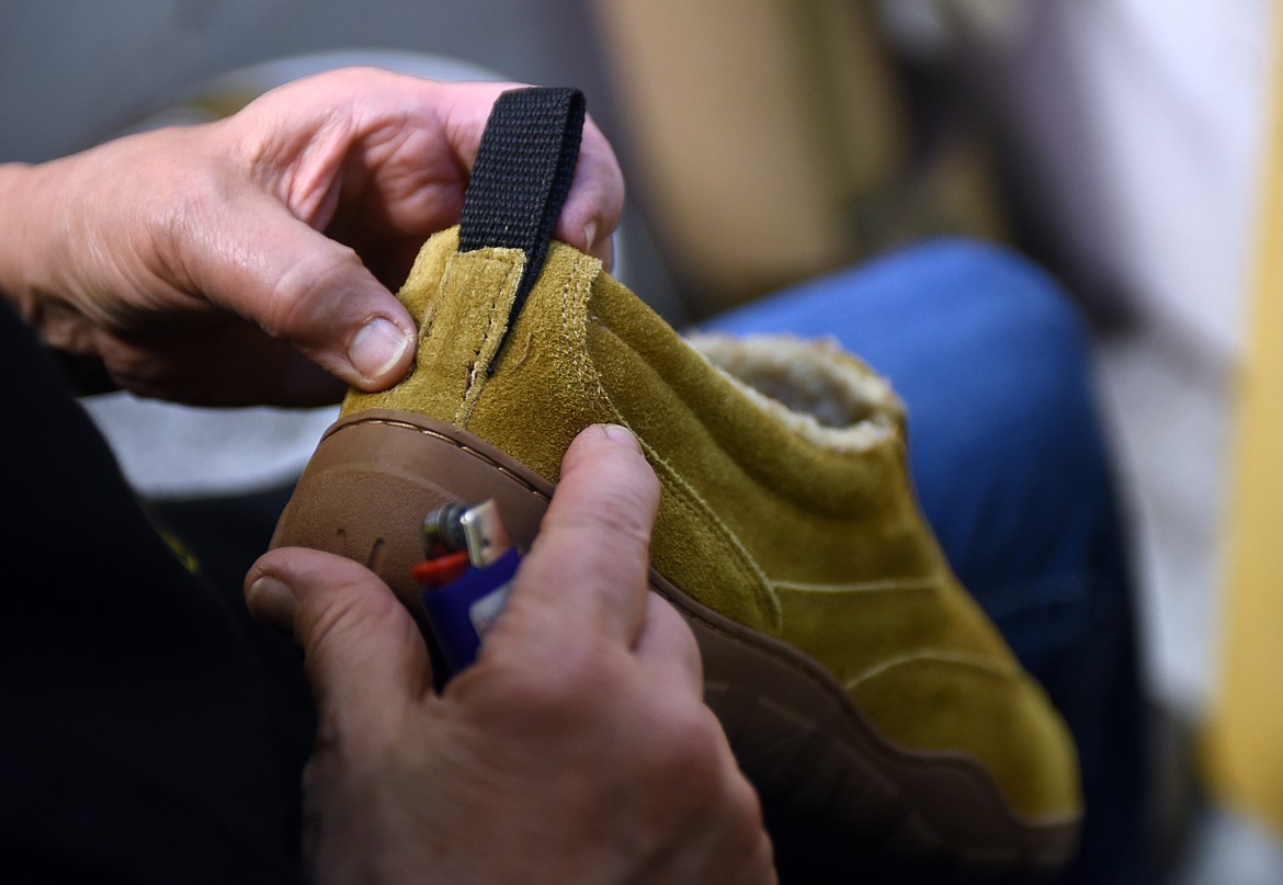 Jenny Thompson checks her work on a shoe.