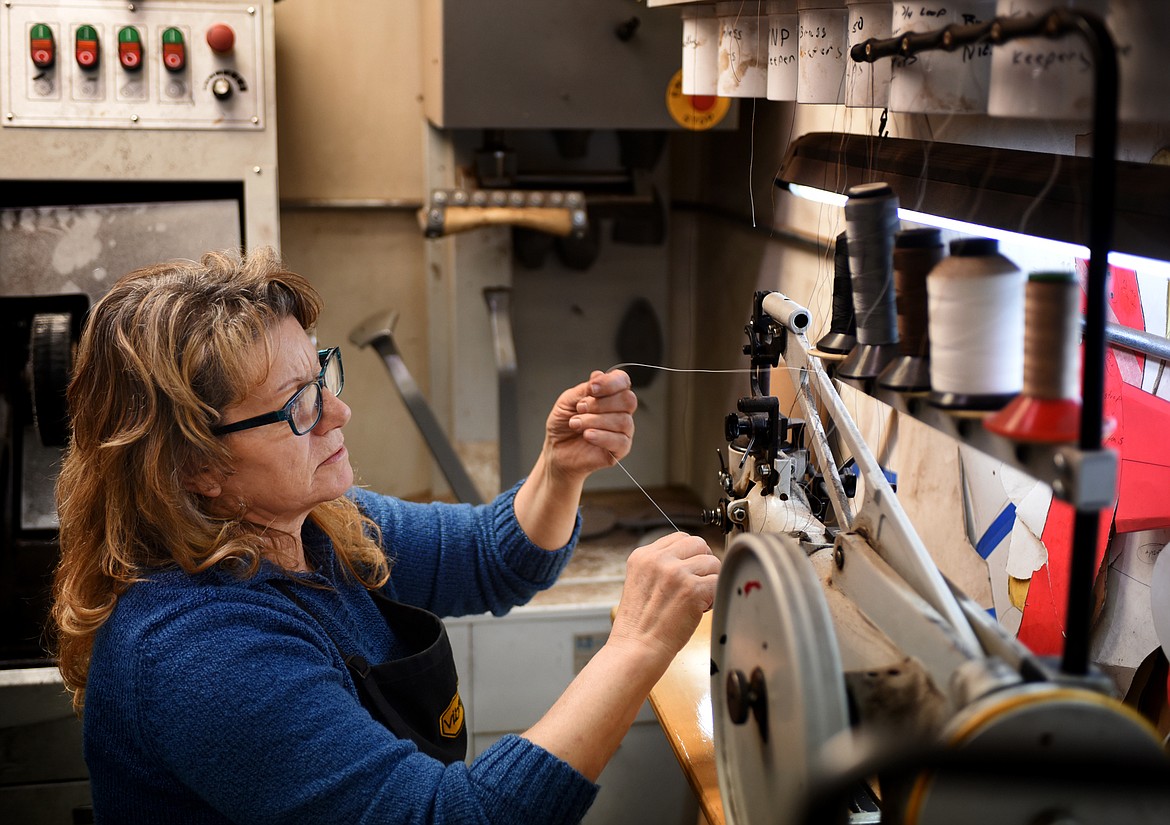 Jenny Thompson sets up to add embroidered patches to a leather jacket.