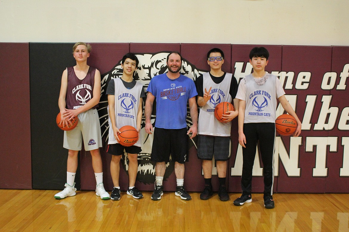 Five foreign exchange students are playing for the Clark Fork Mountain Cats this season. Mads Groenlund, Denmark (left); Wasin Wongwiwat,Thailand; Joe Petersen, Assist. Coach; Nhan Hoang, Vietnam; Ginwan Jung, Korea (far right). Not pictured, Yu Hsiang Lin, Tiawan. (Kathleen Woodford/Mineral Independent)