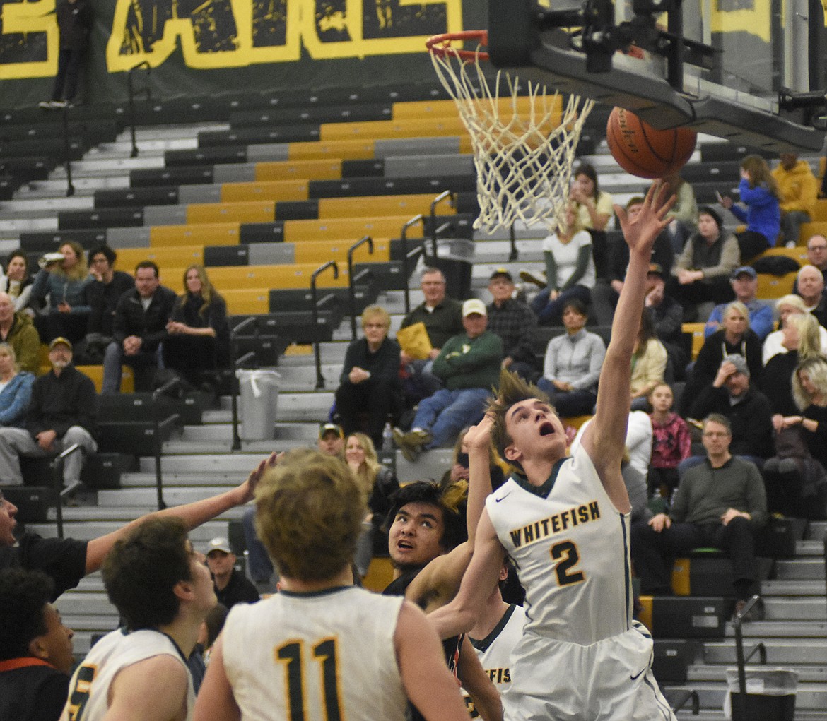 Bodie Smith fights for the layup during the Bulldogs' Senior Night victory over Ronan last Tuesday. (Daniel McKay/Whitefish Pilot)