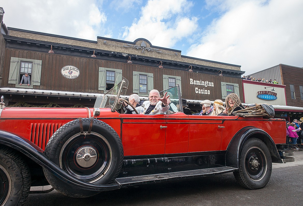 Dale Duff rides his red bus through the parade.