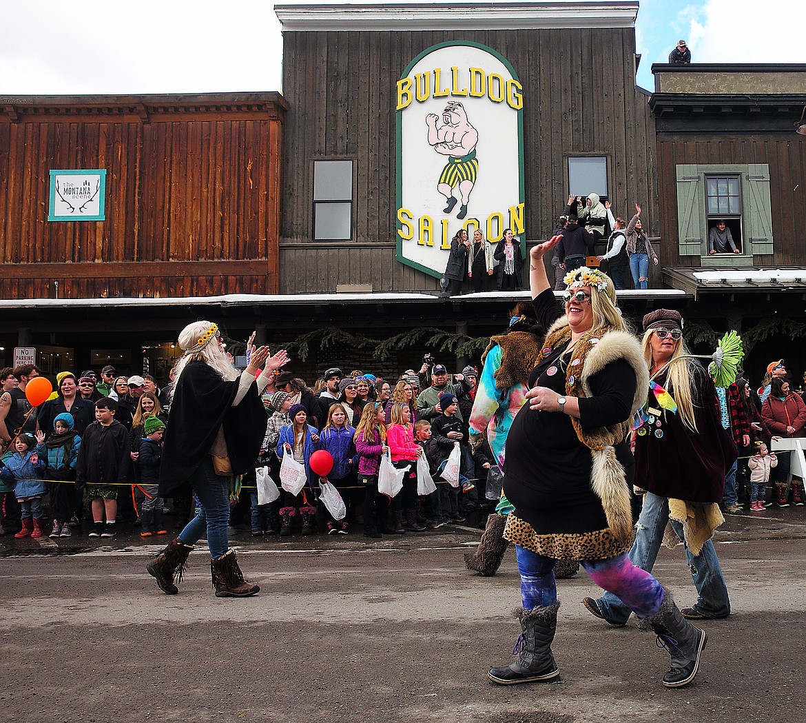 Waving to the crowd as folks watch from the roof of the Bulldog Saloon.