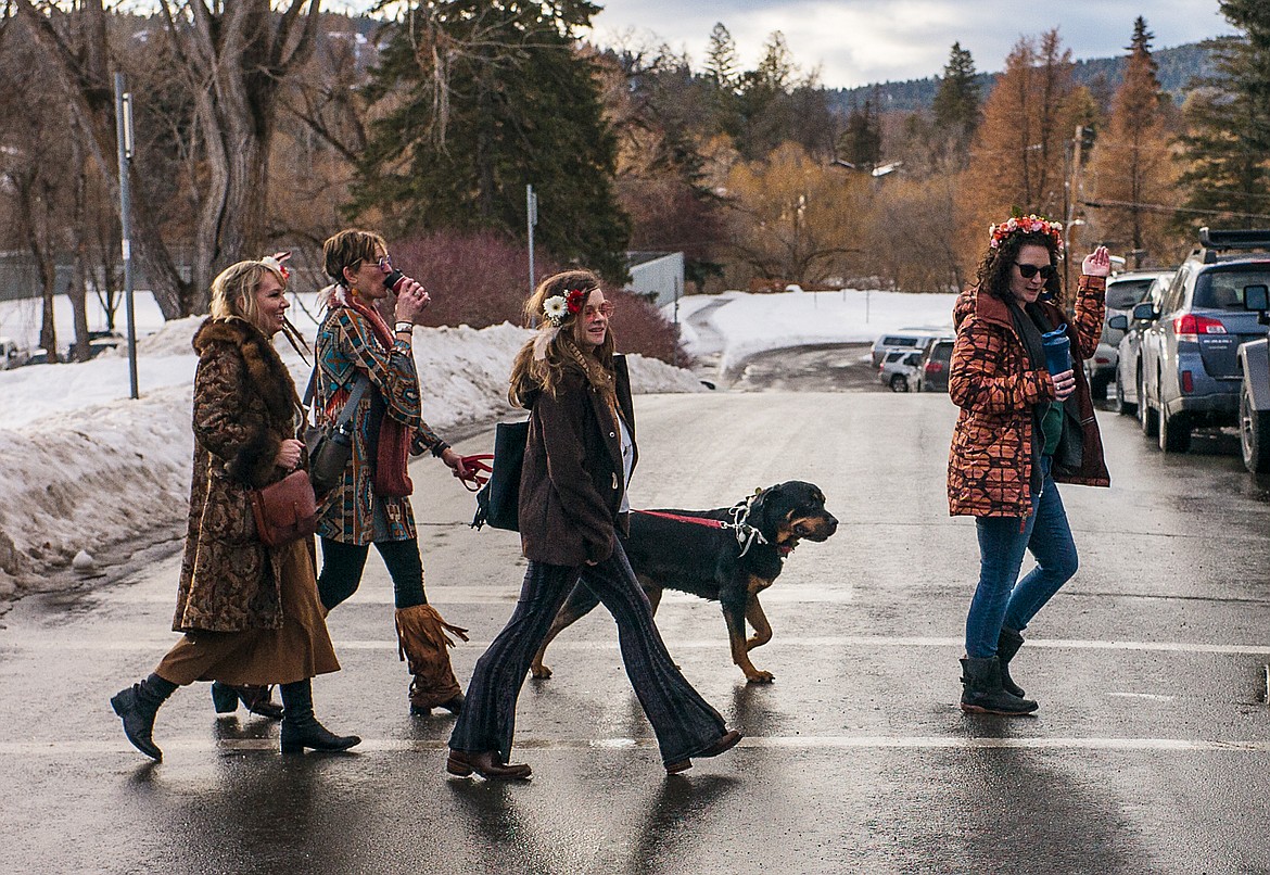 In their &#145;60s amd &#145;70s garb, ladies cross the street.