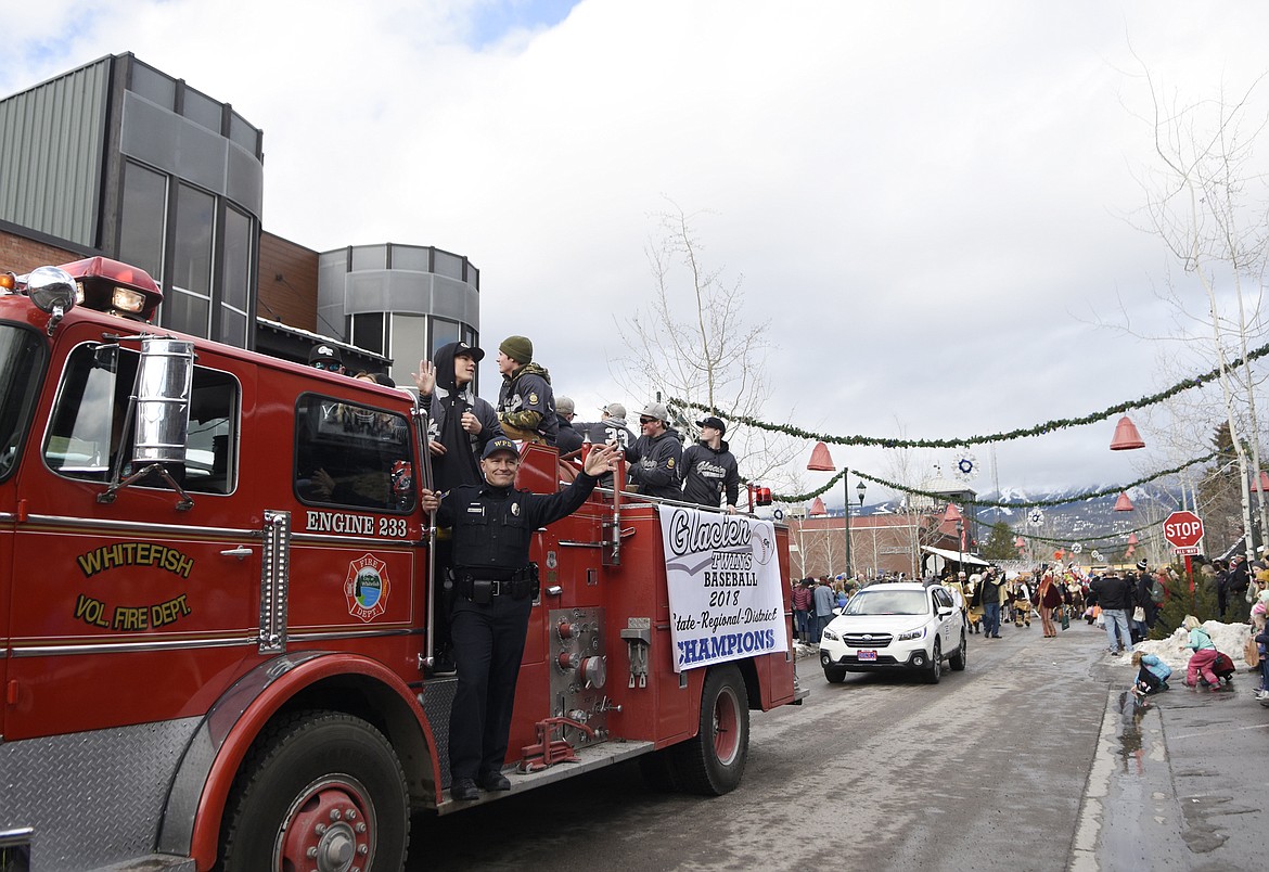 The Glacier Twins ride on a Whitefish Fire Department truck Saturday during the Whitefish Winter Carnival Grand Parade. (Heidi Desch/Whitefish Pilot)