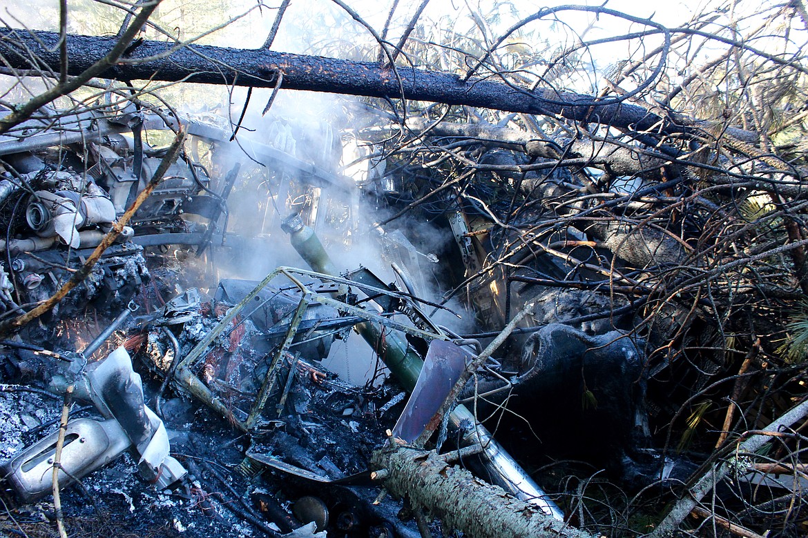 The little remains of what used to be the driver&#146;s cab of the semi-truck and broken trees.