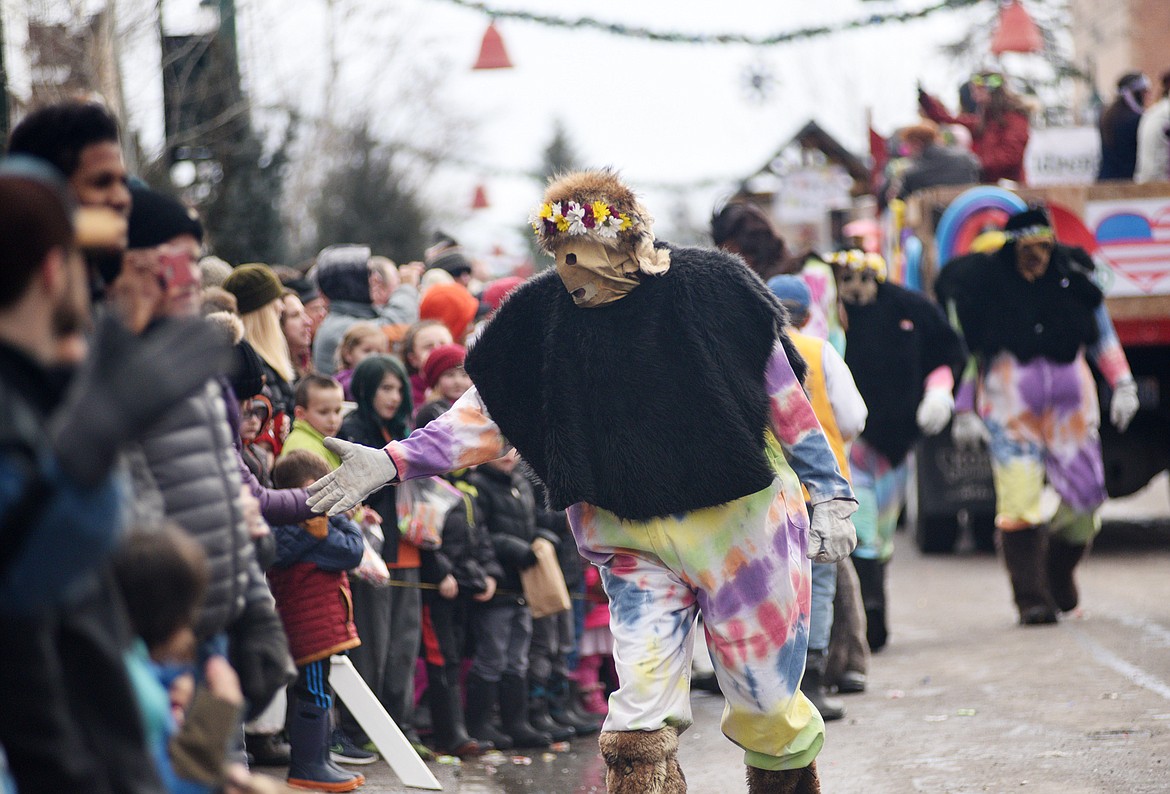A yeti hands out high-fives along the parade route. (Heidi Desch/Whitefish Pilot)