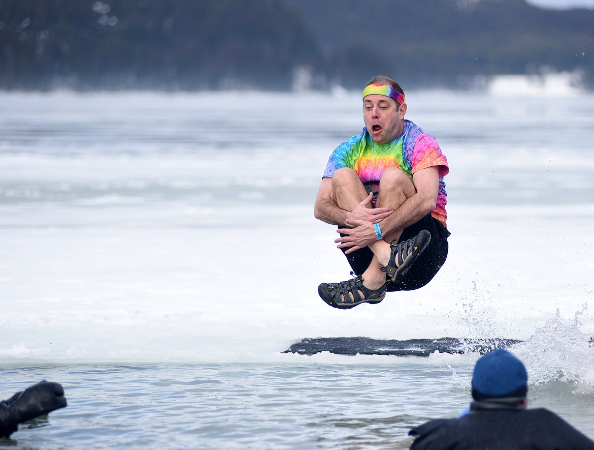A participant does a cannon ball into the icy waters of Whitefish Lake Saturday morning during the Whitefish Winter Carnival Penguin Plunge, which benefits Special Olympics Montana. (Heidi Desch/Whitefish Pilot)