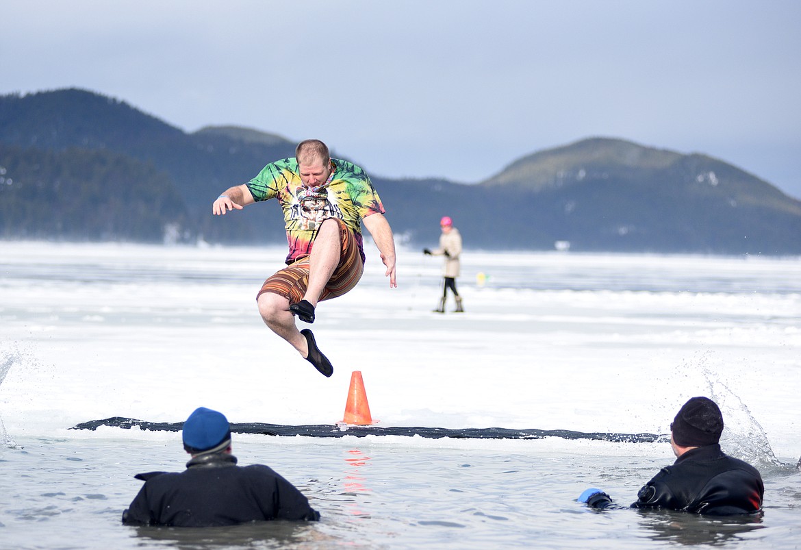 Kyler Morrison made his 19th jump into Whitefish Lake Saturday morning for the annual Whitefish Winter Carnival Penguin Plunge, which benefits Special Olympics Montana. The event celebrated its 20th anniversary. (Heidi Desch/Whitefish Pilot)