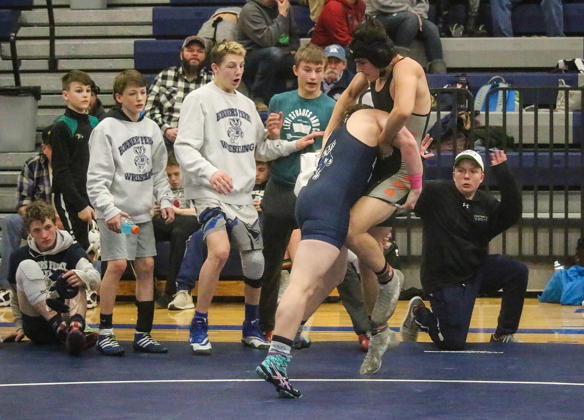 Photos by MANDI BATEMAN
As his teammates react, Bonners Ferry&#146;s Andrew Sandelin-Macintosh attempts a takedown on Timberlake&#146;s Ryder Paslay in a 182-pound match at Saturday&#146;s Bonners Ferry Wrestling Invitational. Sandelin-Macintosh pinned Paslay in 1:05.