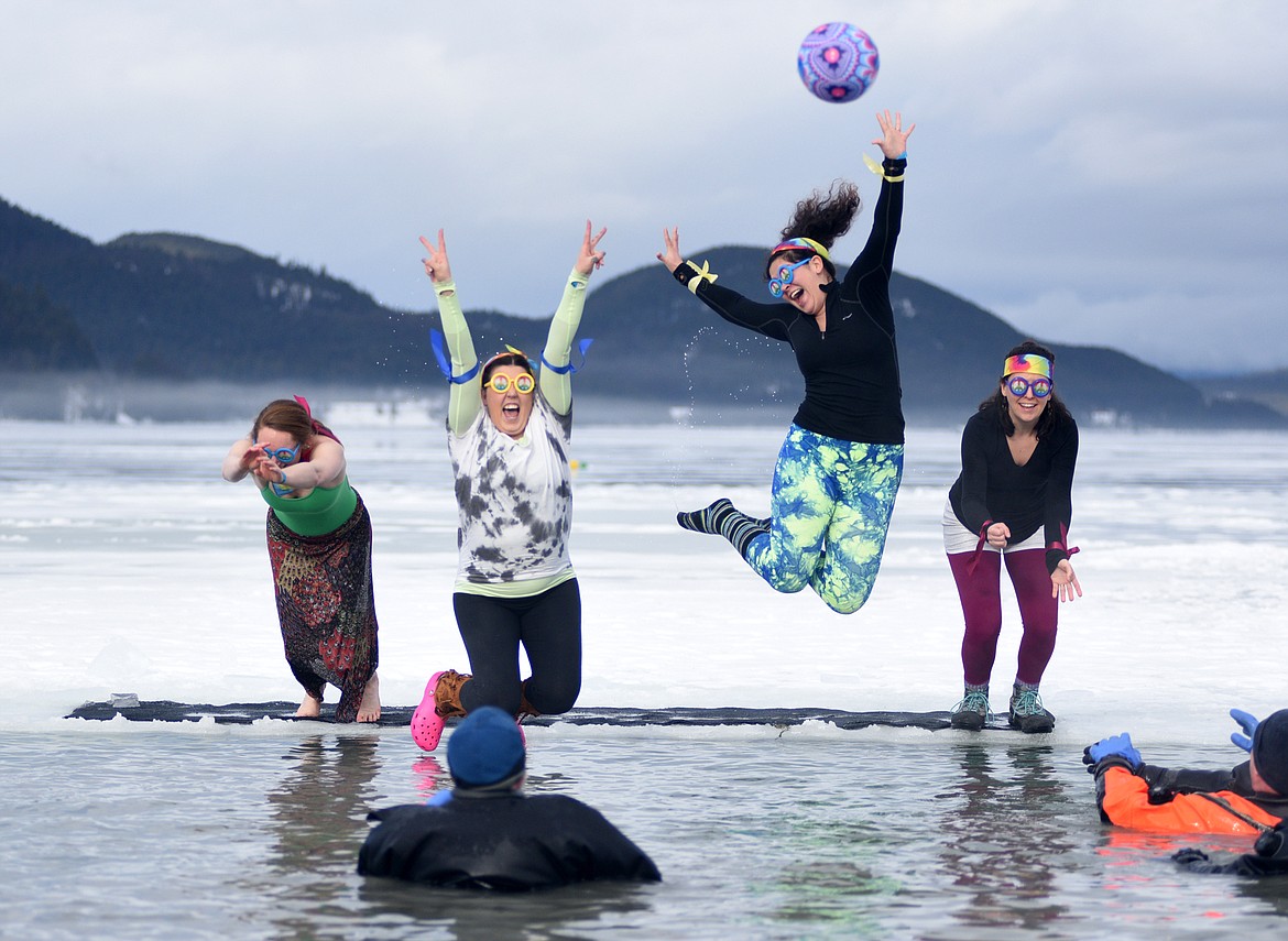 Participants jump into the icy waters of Whitefish Lake Saturday morning during the Whitefish Winter Carnival Penguin Plunge, which benefits Special Olympics Montana. (Heidi Desch/Whitefish Pilot)