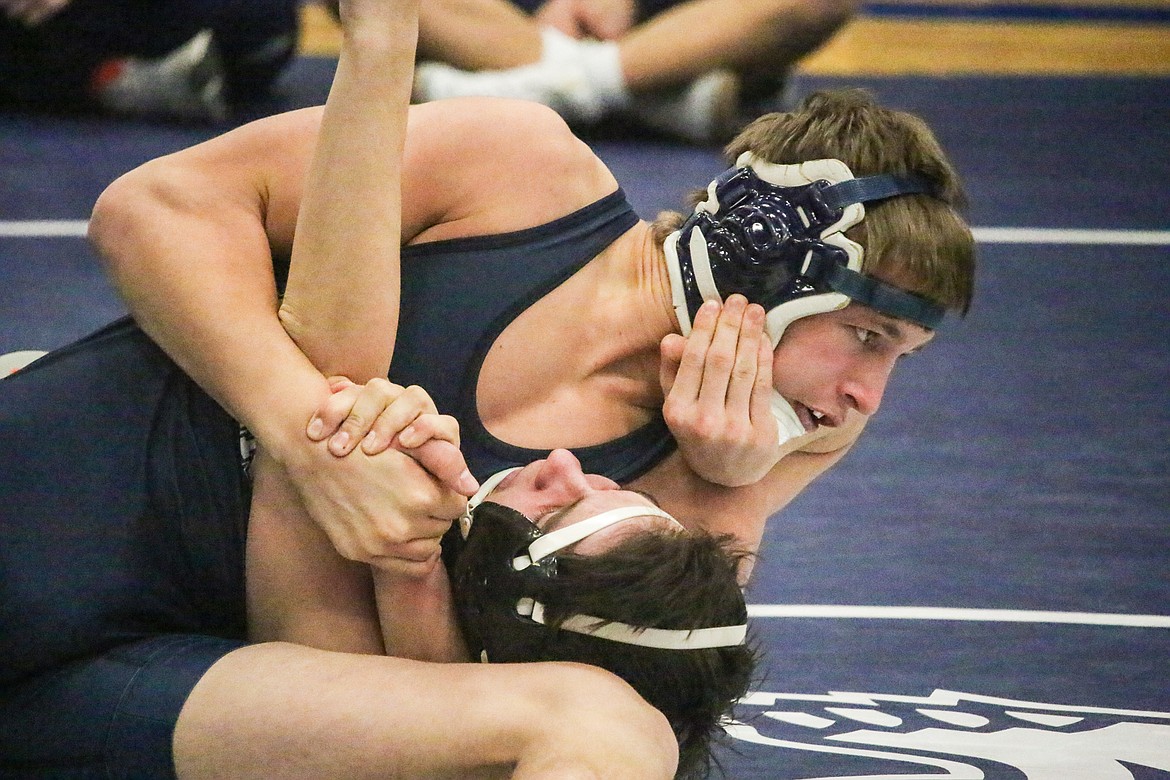 Kyle Smith takes control of his opponent during a 152-pound match.