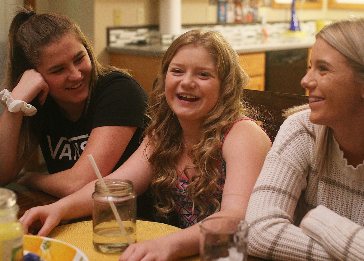 Danika Keyser, 12, center, and her sisters Alex, left, and Rylee share stories about their experience swimming with dolphins while on a Make-A-Wish Foundation Caribbean cruise last October. (LOREN BENOIT/Press)