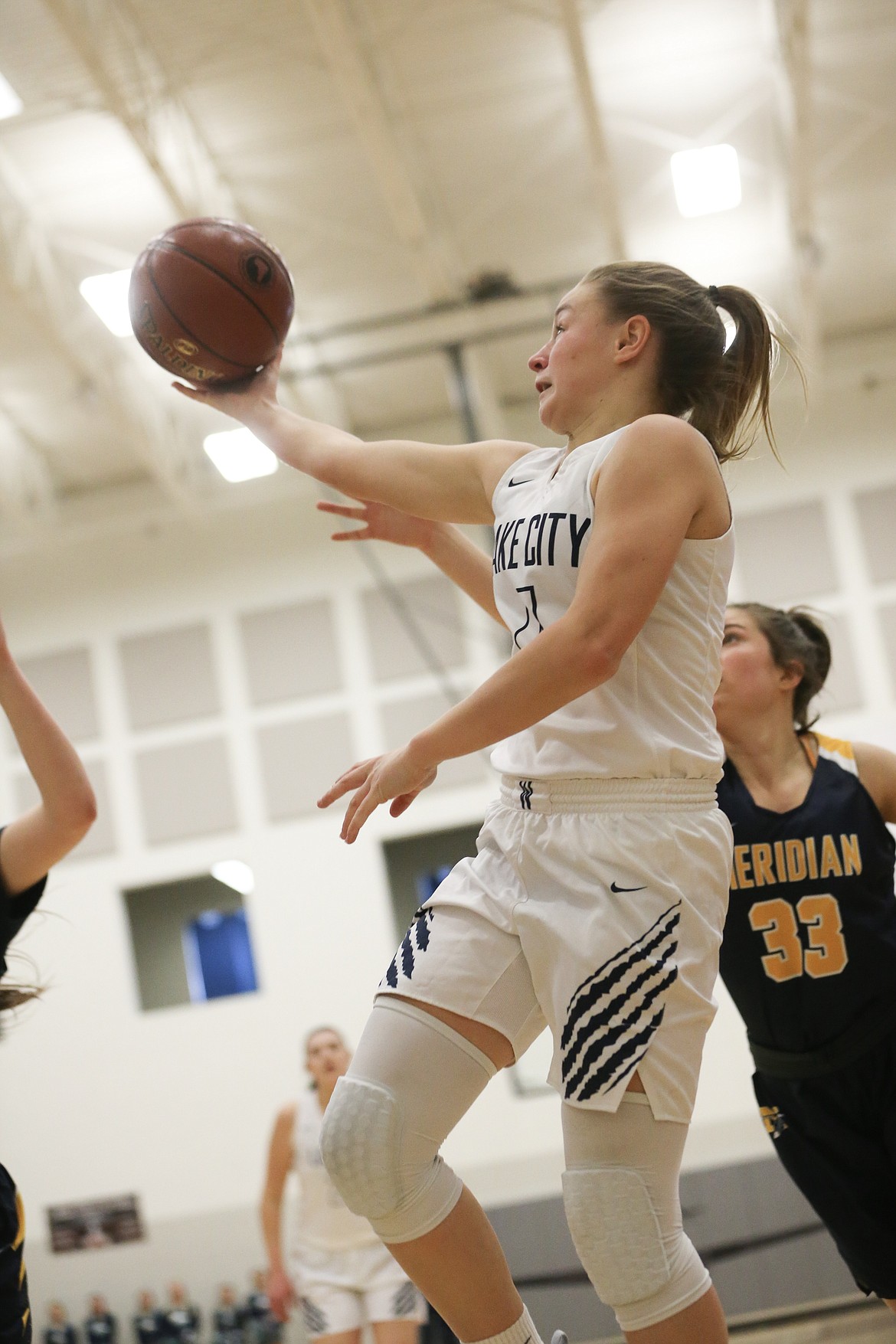 Photo by JASON DUCHOW PHOTOGRAPHY
Chloe Teets of Lake City lays up the ball on a baseline drive against Meridian in the 5A girls consolation championship game Saturday at Ridgevue High in Nampa.