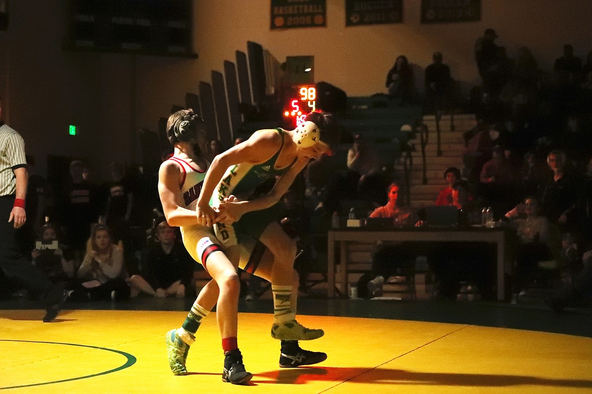 Lakeland freshman Payden Wysong tries escaping the grasp of Sandpoint freshman Jordan Birkhimer during the closing seconds of the 4A 98-pound district championship match on Saturday.

KYLE CAJERO/Bonner County Daily Bee