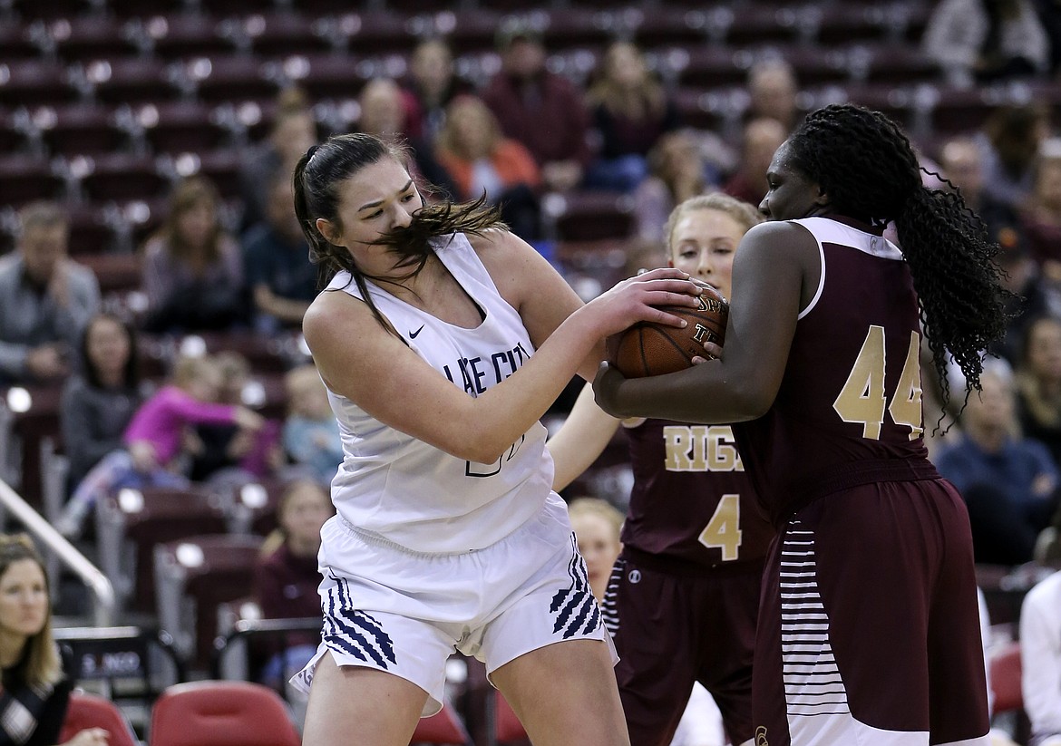 Photo by JASON DUCHOW PHOTOGRAPHY
Brooklyn Rewers of Lake City battles Rigby&#146;s Mateya Mobley for  possession of the ball Friday in a loser-out game of the state 5A girls basketball tournament at the Ford Idaho Center in Nampa.