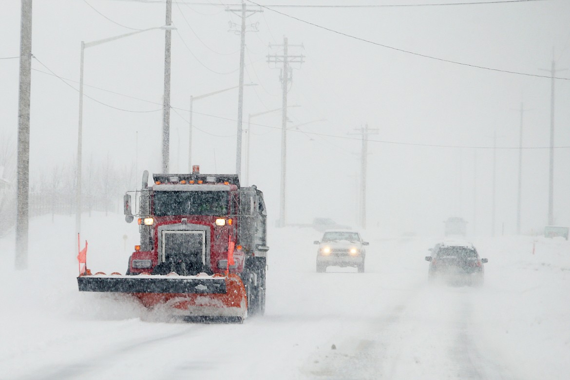 A snow plow clears snow from Poleline Road in Post Falls during Friday's snow storm. (LOREN BENOIT/Press)