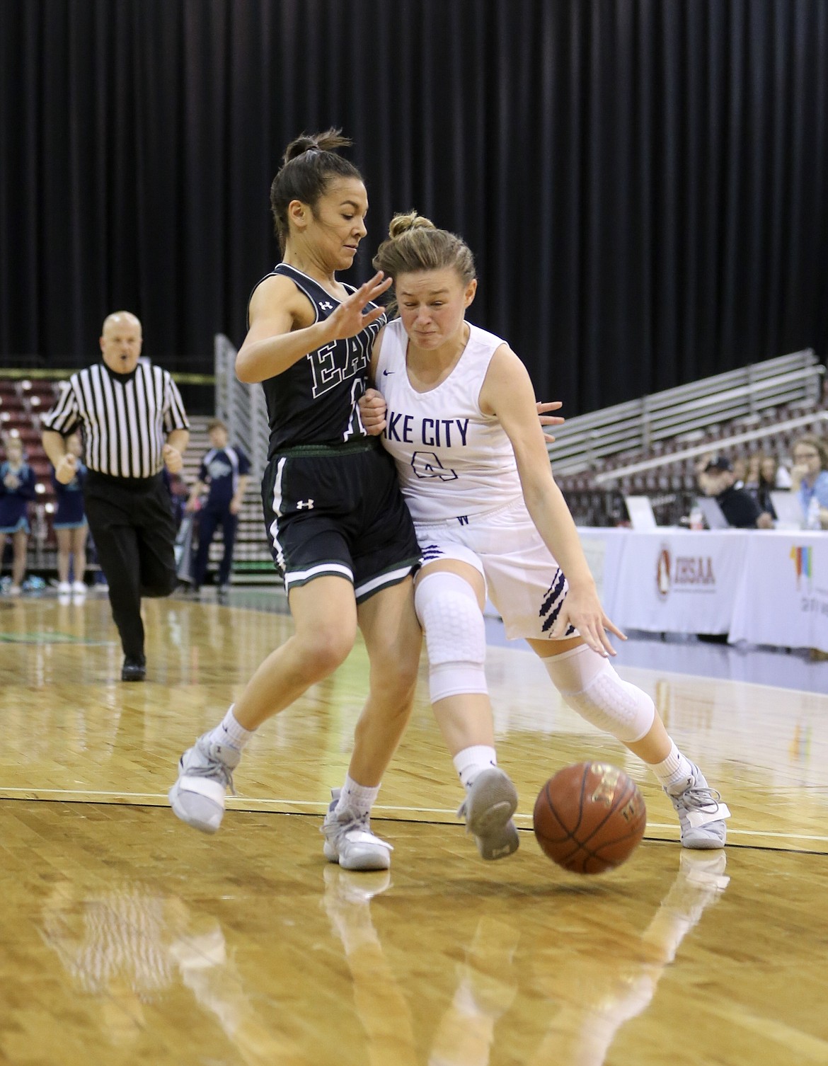 Photo by JASON DUCHOW PHOTOGRAPHY
Chloe Teets of Lake City attempts to drive past an Eagle defender on Thursday in the first round of the state 5A girls basketball tournament at the Ford Idaho Center in Nampa.