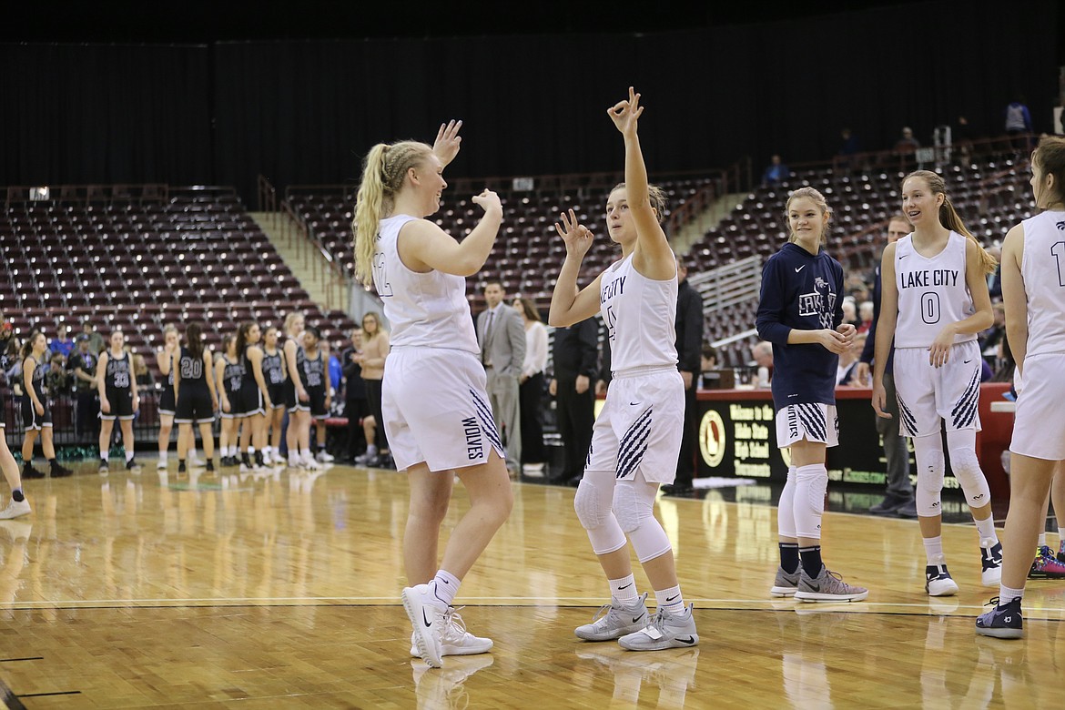 Photo by JASON DUCHOW PHOTOGRAPHY
Bethany Littman, left and Chloe Teets of Lake City during the player introductions before the game vs. Eagle in the first round of the state 5A girls basketball tournament Thursday at the Ford Idaho Center in Nampa.