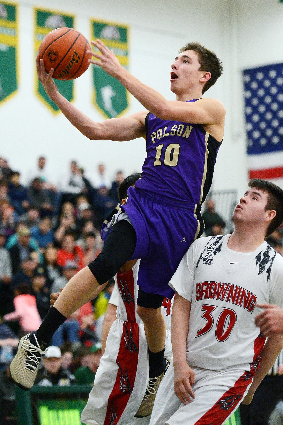 Polson's Ryker Wenderoth (10) drives to the hoop against Browning during the Northwest A District boys' championship game at Whitefish High School on Saturday. Browning won, 78-50. (Casey Kreider/Daily Inter Lake)