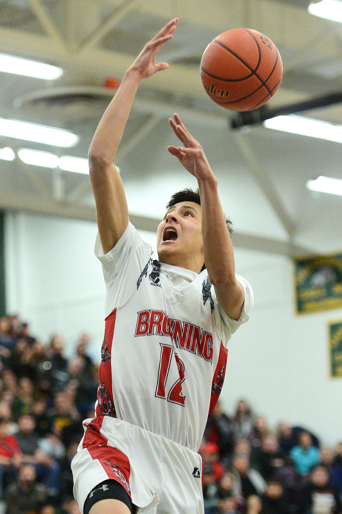 Browning's Ethan Running Crane (12) loses the ball as he goes up for a dunk attempt against Polson during the Northwest A District boys' championship game at Whitefish High School on Saturday. Browning won, 78-50. (Casey Kreider/Daily Inter Lake)