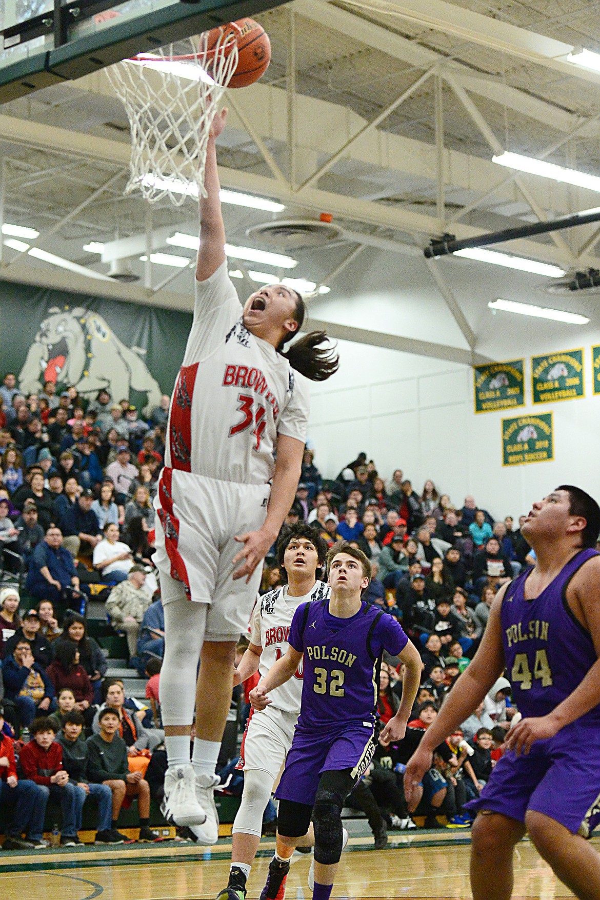 Browning's Deion Mad Plume (34) scores on a fast break against Polson during the Northwest A District boys' championship game at Whitefish High School on Saturday. Browning won, 78-50. (Casey Kreider/Daily Inter Lake)