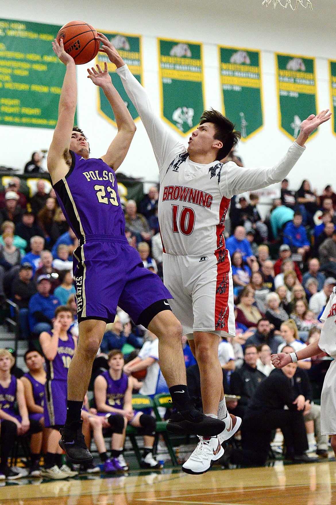 Polson's Parker Toth (23) has his shot blocked by Browning's Riley Spoonhunter (10) during the Northwest A District boys' championship game at Whitefish High School on Saturday. Browning won, 78-50. (Casey Kreider/Daily Inter Lake)