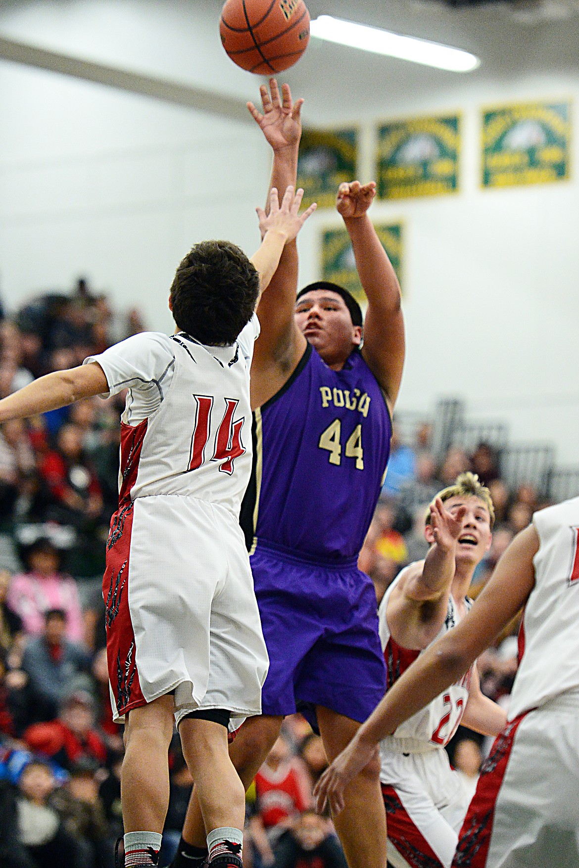 Polson's Micah Askan (44) shoots over Browning's Derek Sharp (14) during the Northwest A District boys' championship game at Whitefish High School on Saturday. Browning won, 78-50. (Casey Kreider/Daily Inter Lake)