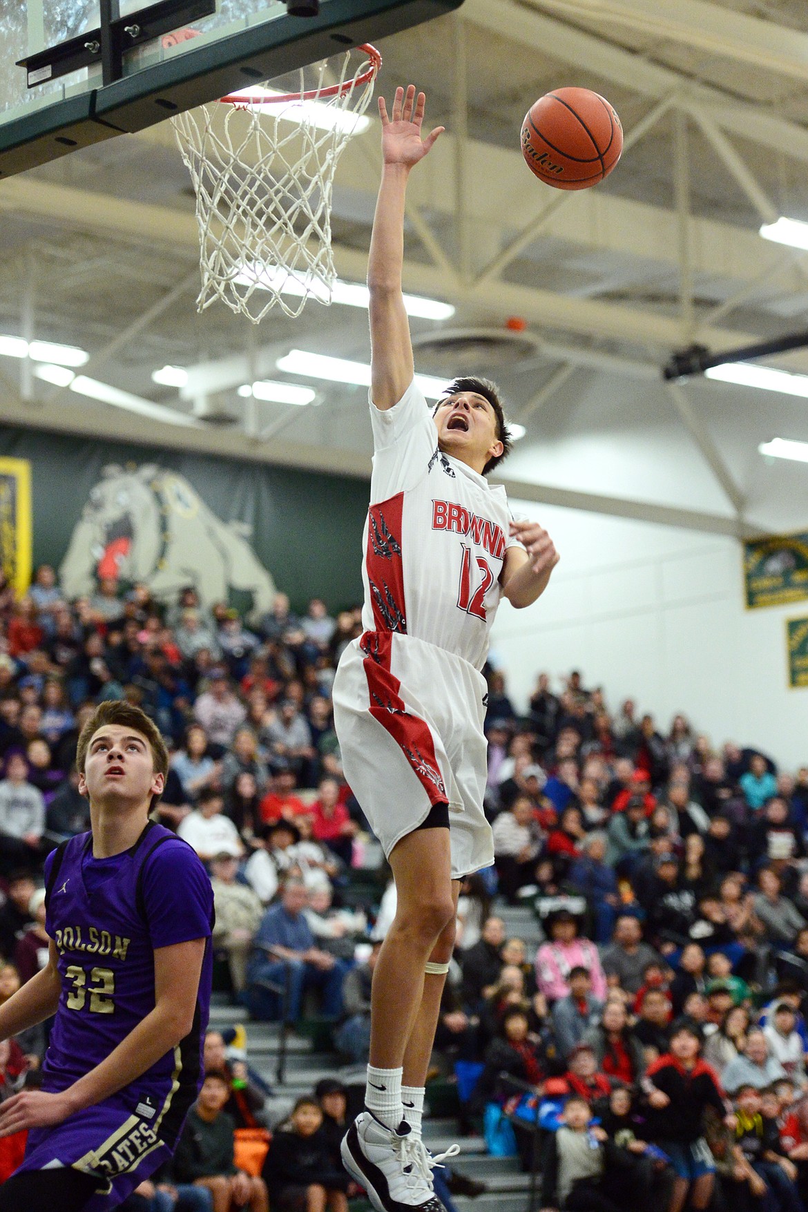 Browning's Ethan Running Crane (12) loses the ball as he goes up for a dunk attempt against Polson during the Northwest A District boys' championship game at Whitefish High School on Saturday. Browning won, 78-50. (Casey Kreider/Daily Inter Lake)