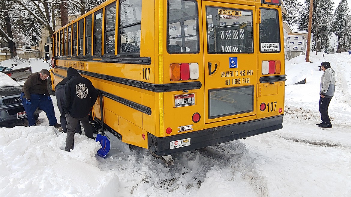 A Coeur d'Alene school bus got stuck in the snow around noon Wednesday on 10th Street after the chains on one of the wheels broke, said Scott Maben the school district's communications director. Several students were transferred to another bus so they could get to their destinations, while school district workers brought new chains to the bus so it could gain traction and get moving again. (MARK ENEGREN/Courtesy)