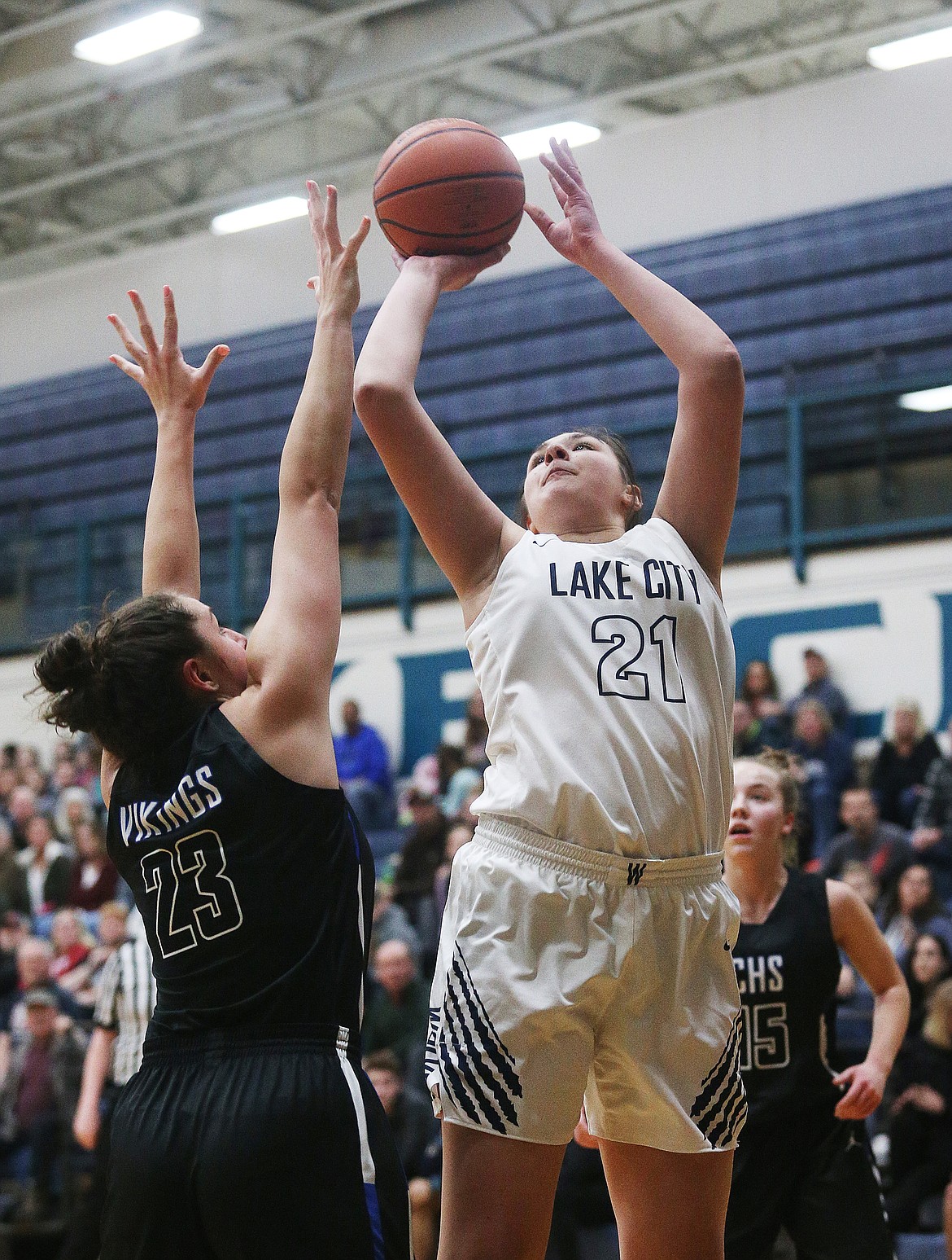 Lake City's Brooklyn Rewers goes for a layup while defended by Coeur d'Alene's Kelly Horning in a game on Feb. 5. (LOREN BENOIT/Press)