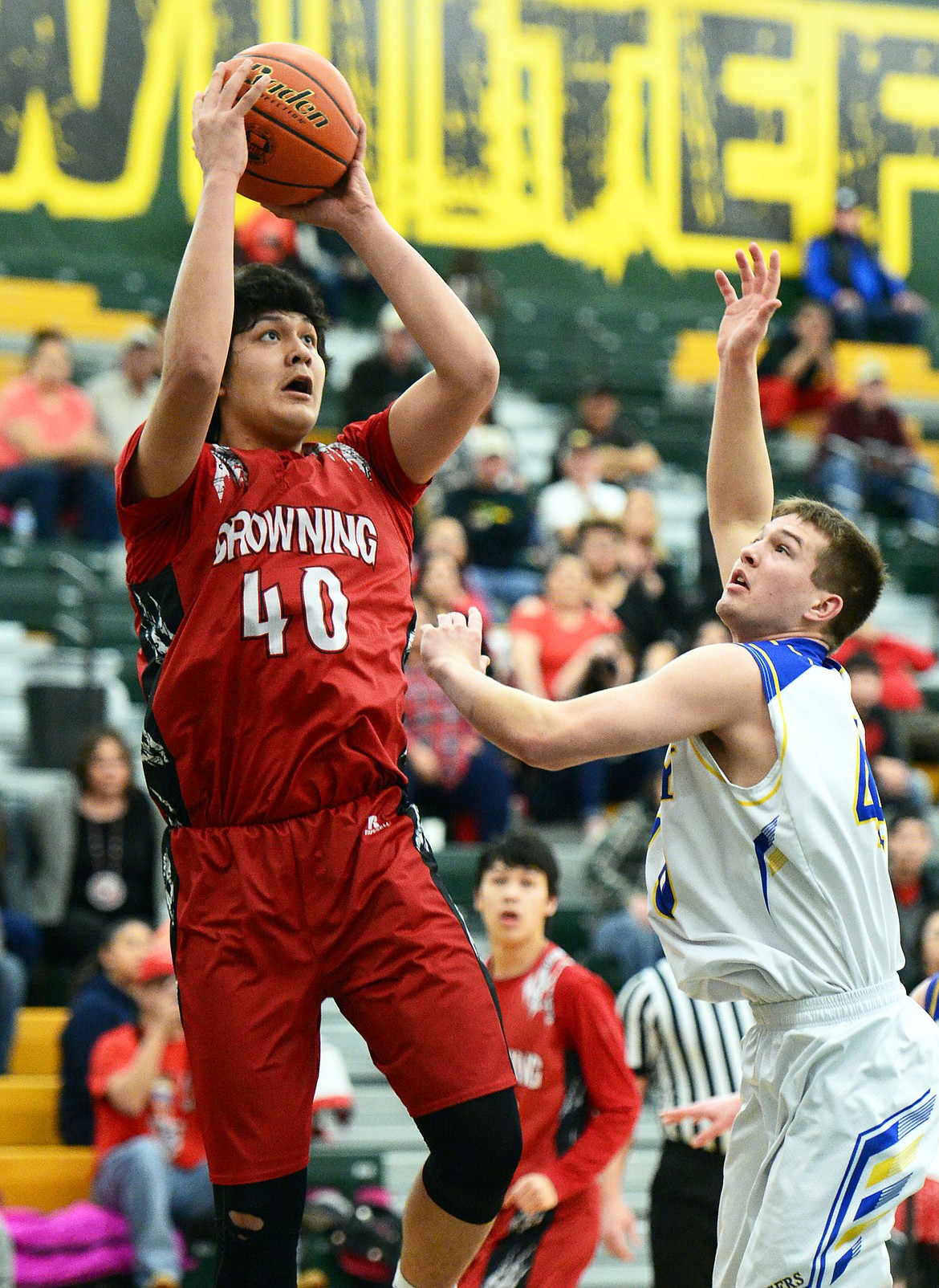 Browning's Tyree Whitcomb (40) shoots over Libby's Tim Goodman (40) at Whitefish High School on Friday. (Casey Kreider/Daily Inter Lake)