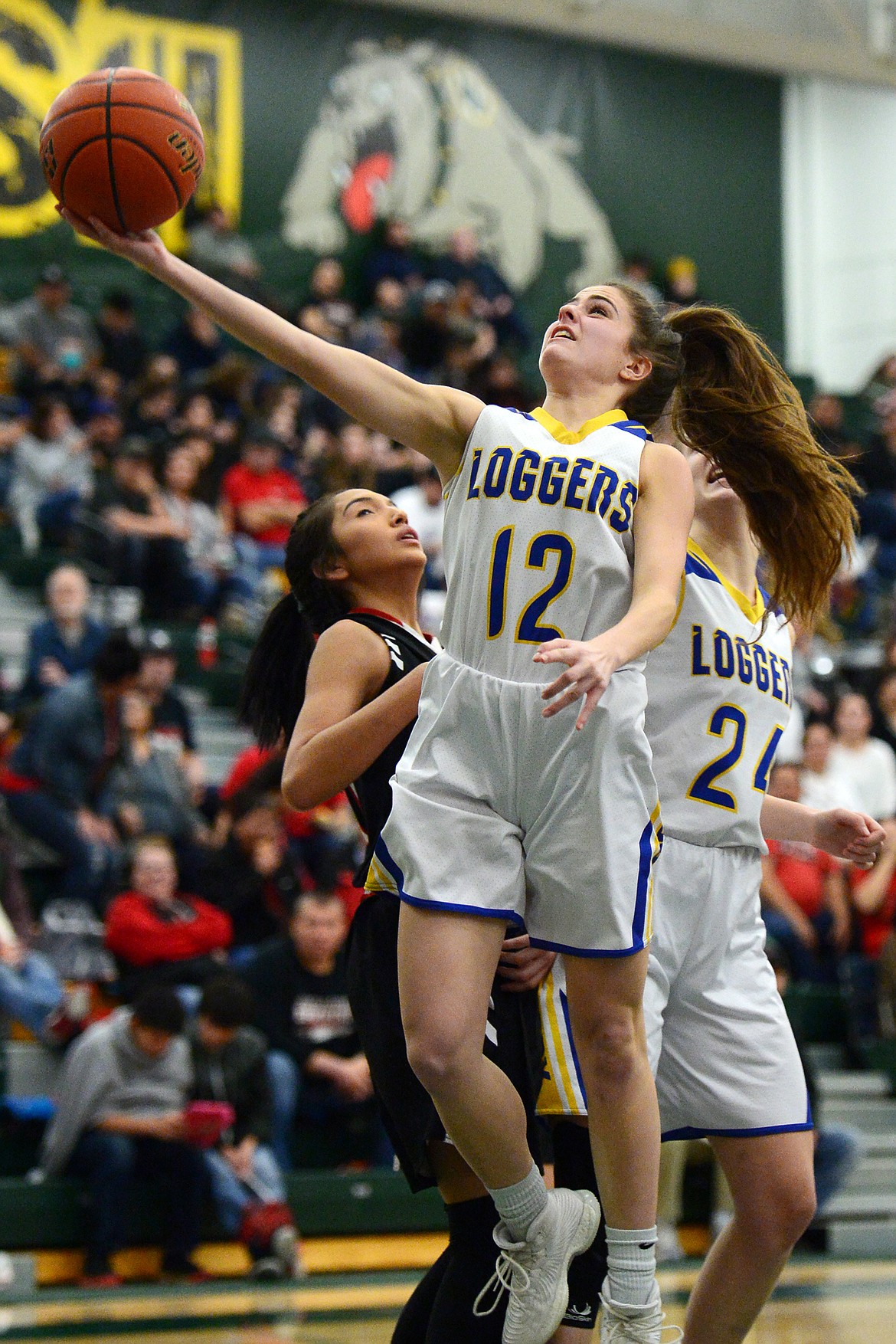 Libby's Alli Collins (12) drives to the basket against Browning at Whitefish High School on Friday. (Casey Kreider/Daily Inter Lake)