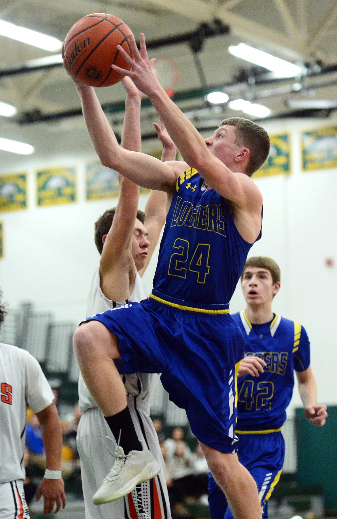 Libby's Jay Beagle (24) drives to the hoop against Ronan at Whitefish High School on Thursday. (Casey Kreider/Daily Inter Lake)