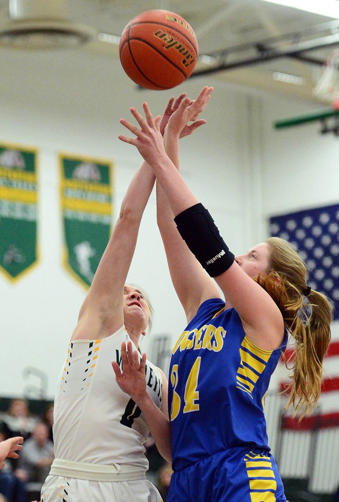 Libby's McKenzie Proffitt (34) looks to shoot with Whitefish's Kit Anderson (0) defending at Whitefish High School on Thursday. (Casey Kreider/Daily Inter Lake)