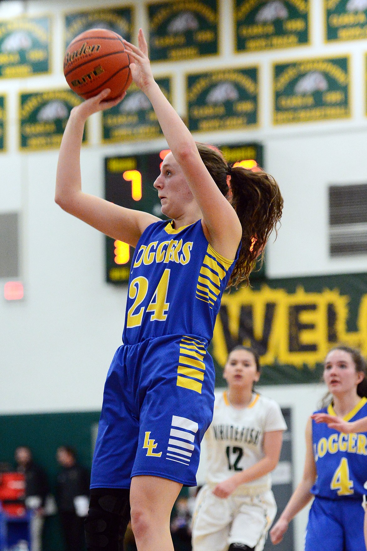 Libby's Jayden Winslow (24) pulls up for a jumper from the elbow against Whitefish at Whitefish High School on Thursday. (Casey Kreider/Daily Inter Lake)