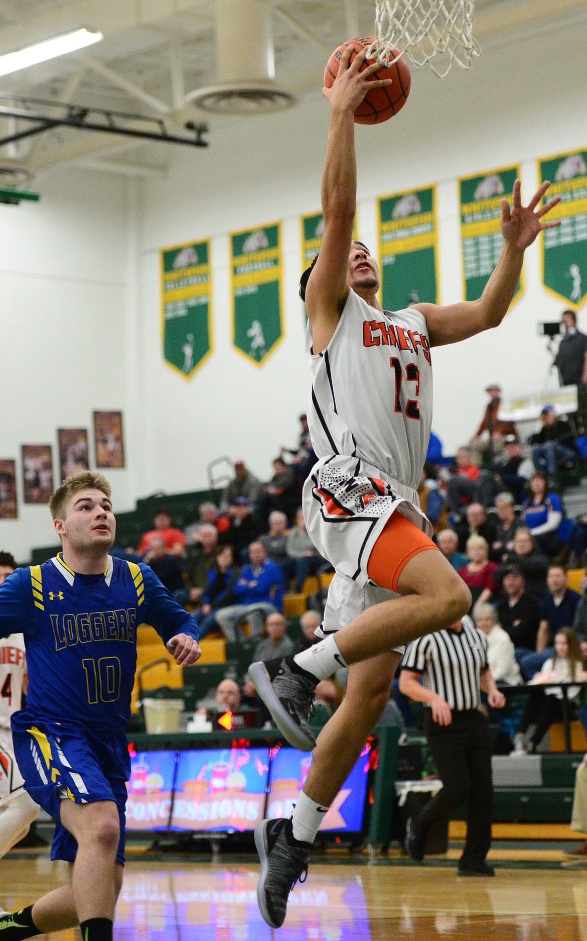 Ronan's Jacob Gatch (13) drives to the hoop against Libby at Whitefish High School on Thursday. (Casey Kreider/Daily Inter Lake)