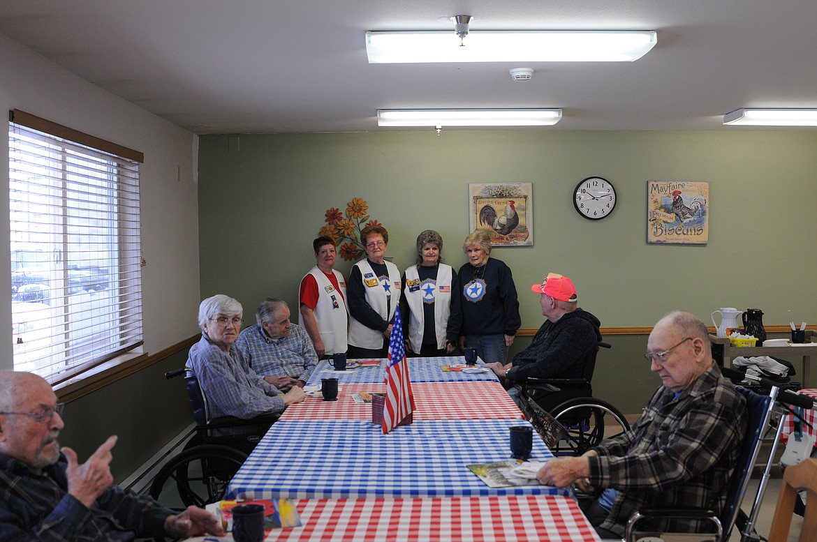 Libby Care Center resident veterans eat cookies donated by Rosauers during a Valentine&#146;s Day party that American Legion Auxiliary Austin Reedy Unit 97 members organized on Thursday at the Libby Care Center. (Rima Austin/The Western News)
