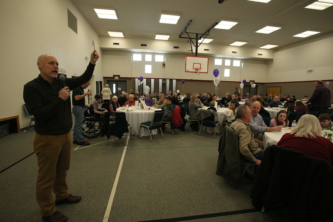 Pastor Kurt Staeuble reminds everyone how to donate to Team McKenna during Jen McKenna&#146;s send-off party Sunday at Coeur d&#146;Alene Bible Church. (DEVIN WEEKS/Press)