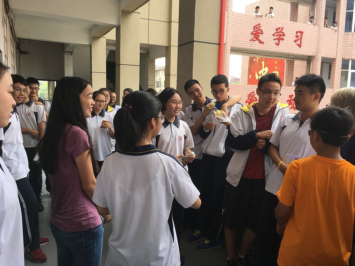Sally Weber (left) visits with students at a high school during the trip her family took to China. (Courtesy photo)