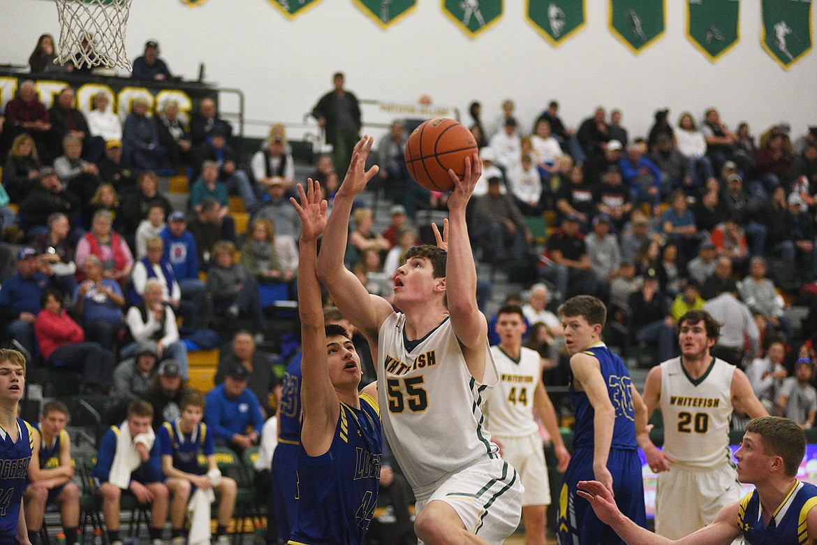 Dillon Botner drives down the lane against Libby on Saturday in the third/fourth place game between Whitefish and Libby in the Class A District Tournament. (Daniel McKay/Whitefish Pilot)