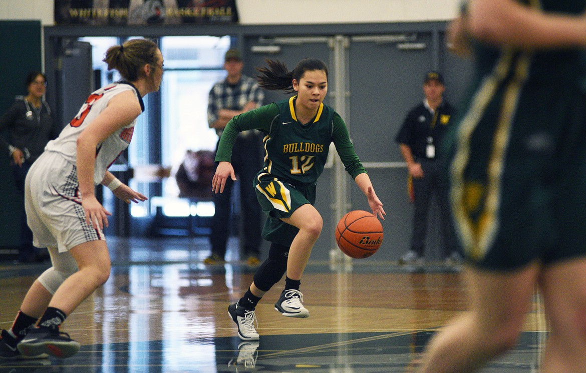Jasmine Matern pushes the ball up the court against Ronan in the Class A District Tournament on Saturday. (Daniel McKay/Whitefish Pilot)