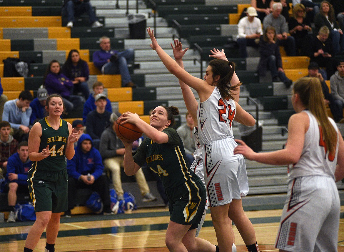 Gracie Smyley fights under the basket against Ronan in the Class A District Tournament on Saturday. (Daniel McKay/Whitefish Pilot)