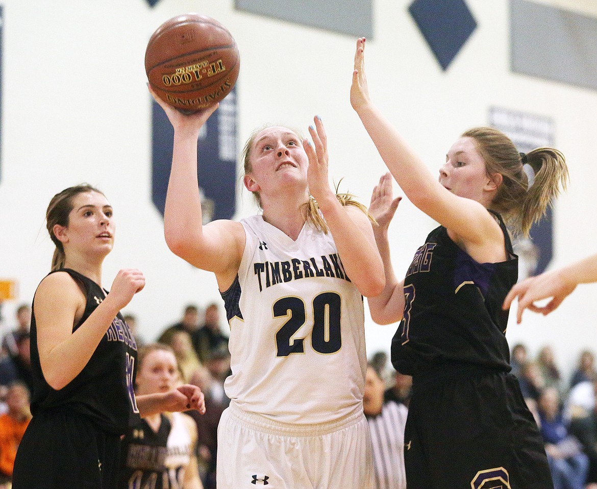 Timberlake&#146;s Brooke Jessen drives toward the basket between Kellogg&#146;s Kaitlin Senteney, right, and Taeya Sheppard during the 3A District 1 girls basketball championship game in Spirit Lake last Thursday night. The Tigers defeated Kellogg 52-19.