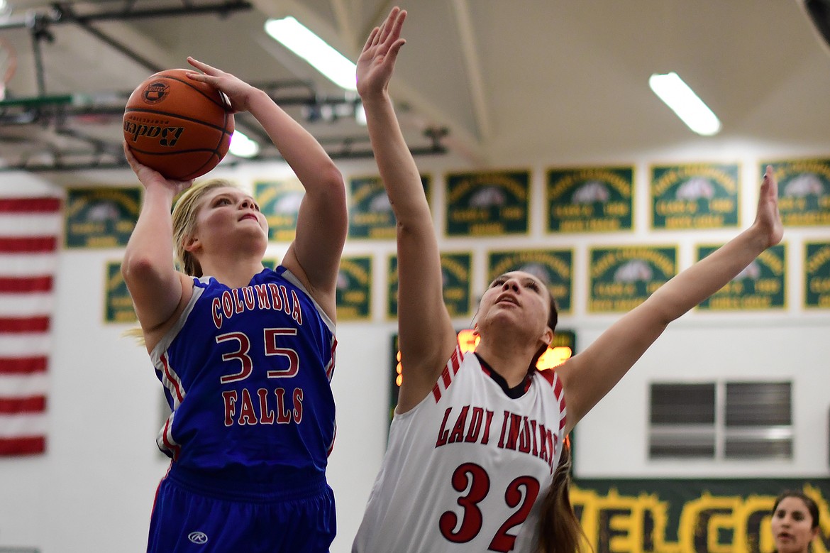 Trista Cowan goes up over Browning&#146;s Taylor Jordan for two of her 14 points Saturday. (Jeremy Weber photo)